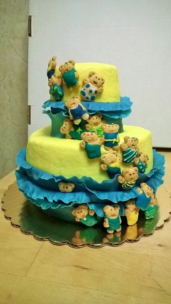 6" & 3" cakes, chocolate with buttercream icing, fondant ruffles & royal icing decorated Teddy Graham bear cascade.  Recipient's favorite colors are blue & yellow.